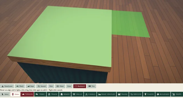 Extending a bare green baseboard with the Baseboard tool, the new piece shown as a green outline over the floor